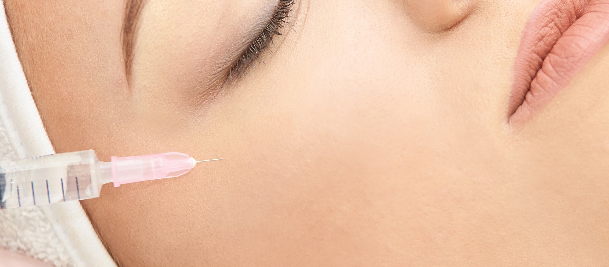 Woman face cosmetology treatment. Biorevitalization skin therapy. Doctor insert filler. Girl clinic