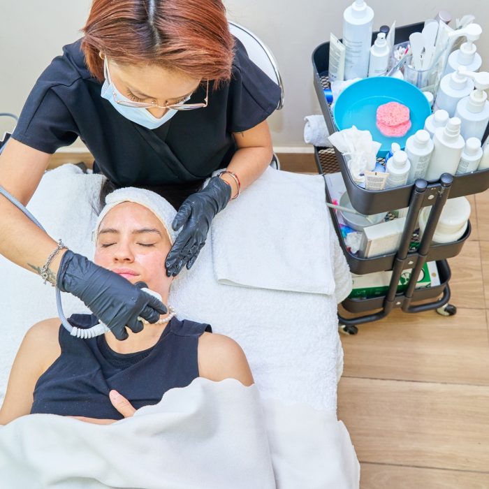 Rejuvenating facial treatment. Model getting lifting therapy massage in a beauty SPA salon.